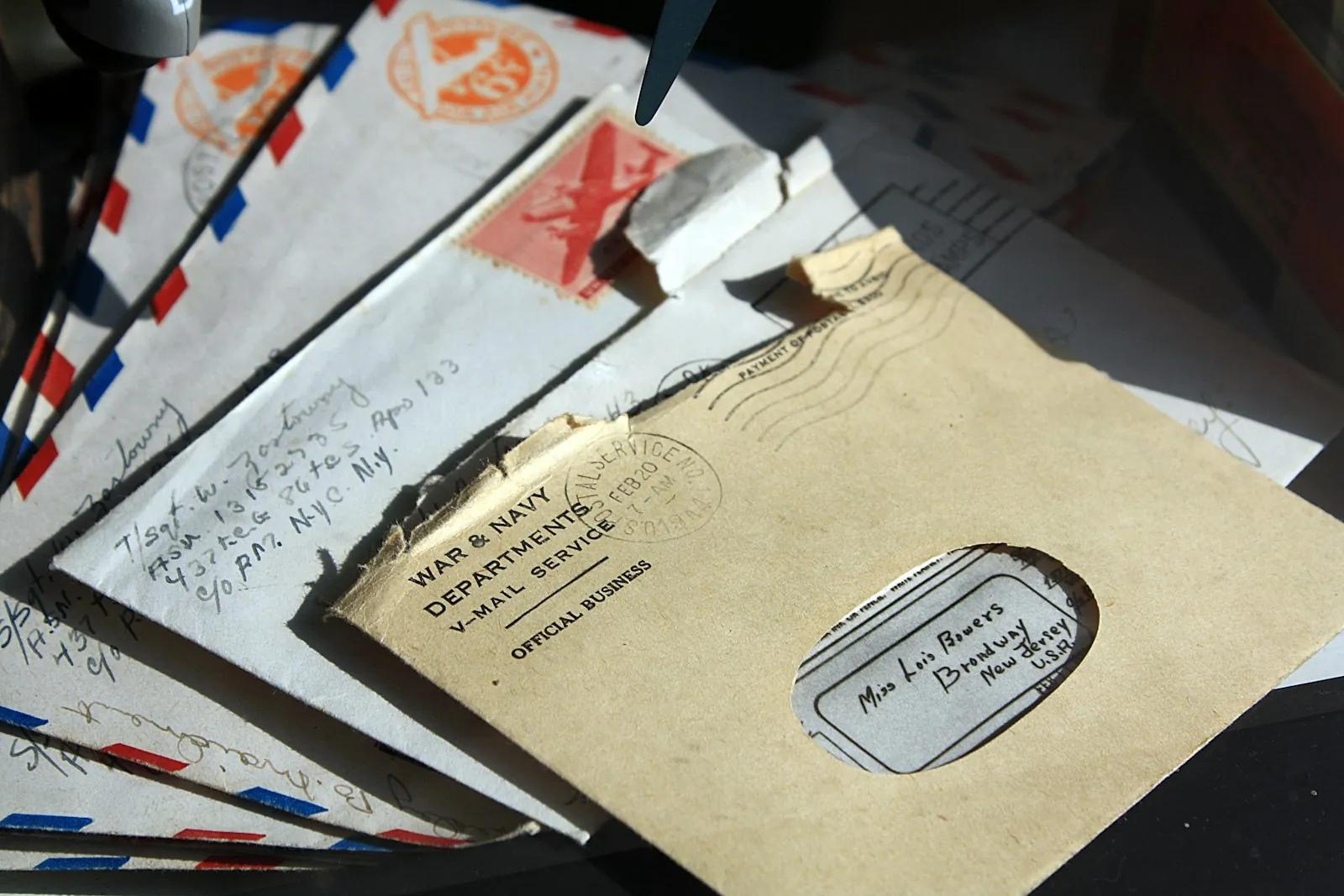 A pile of opened paper envelopes