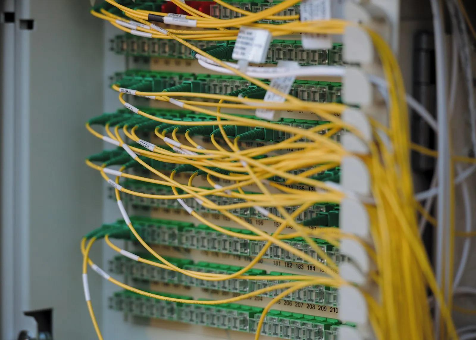 Yellow and green patch cables neatly connected to a panel