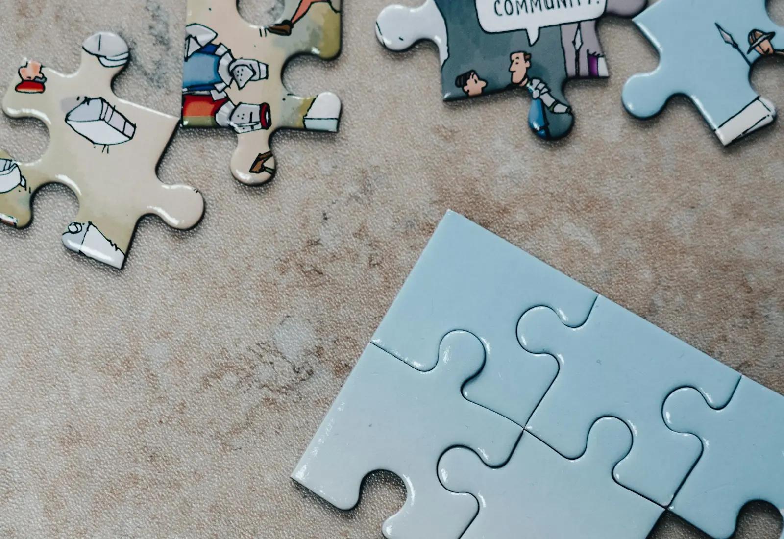 Jigsaw puzzle pieces scattered on a stone surface