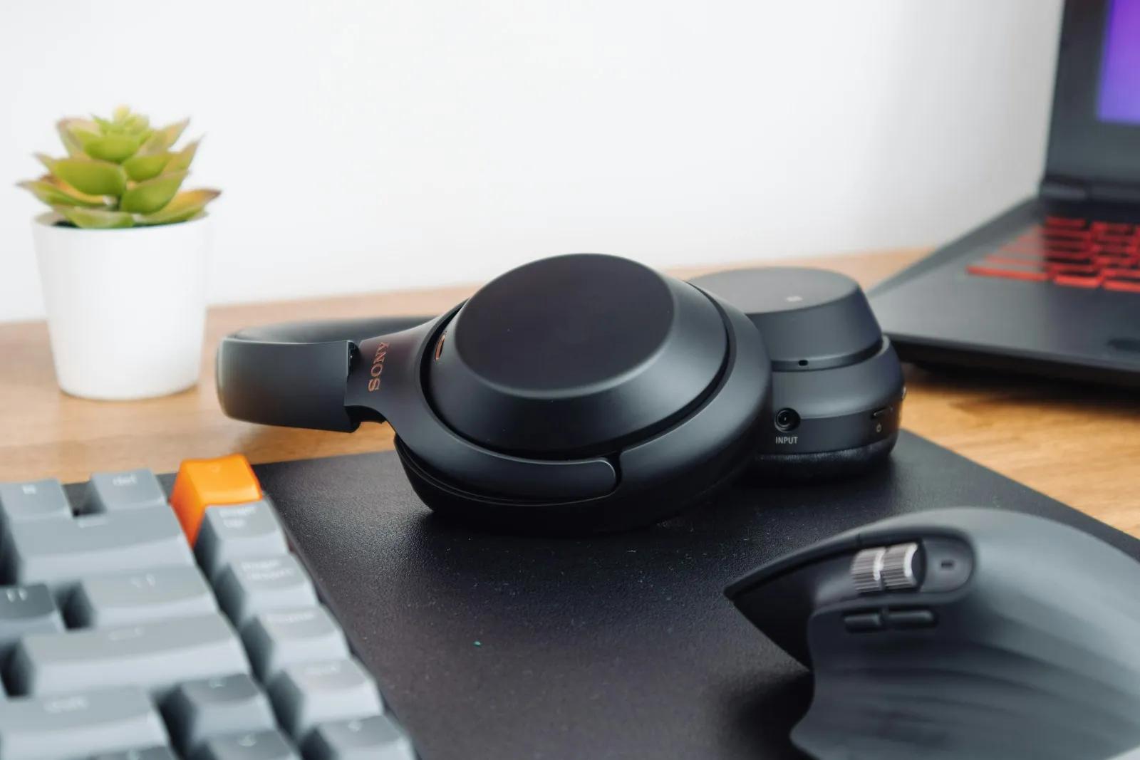 Black headphones resting on a keyboard