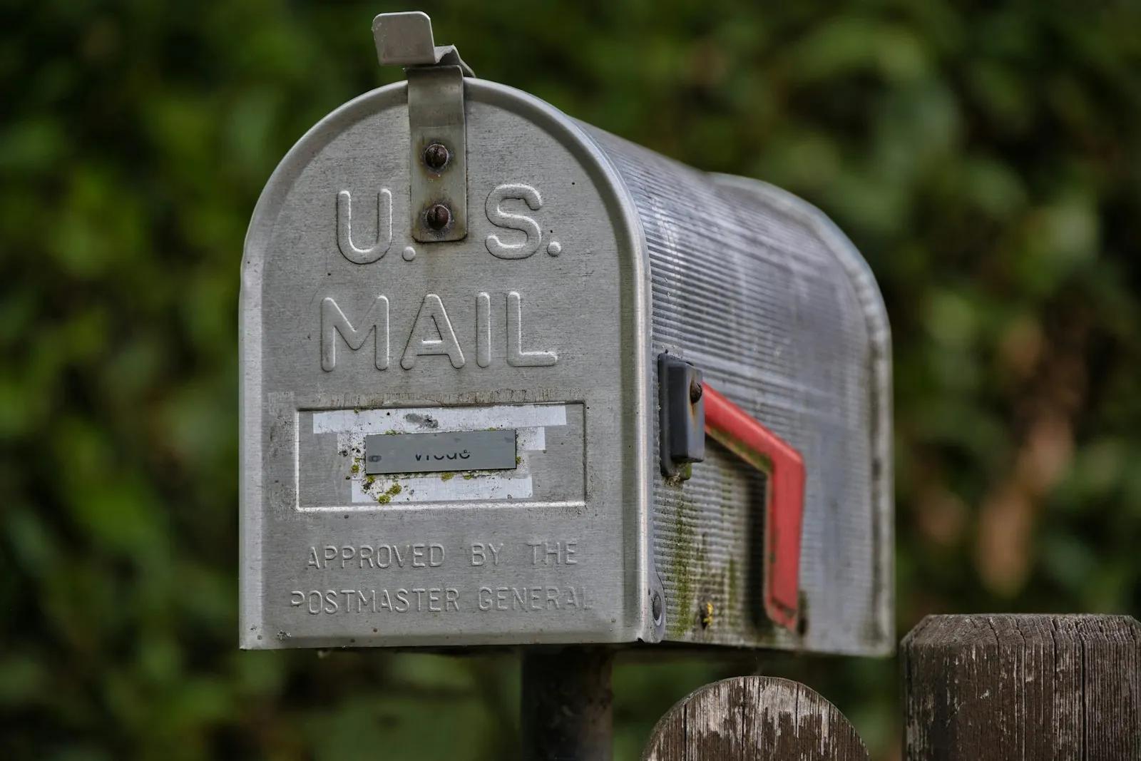 Weathered mailbox with its red flag raised