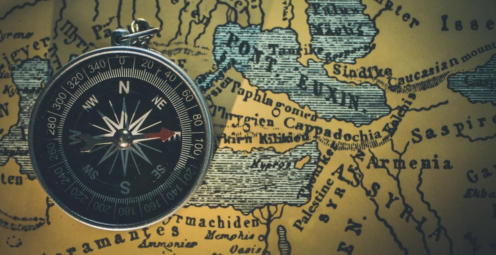 A compass lying on an old map