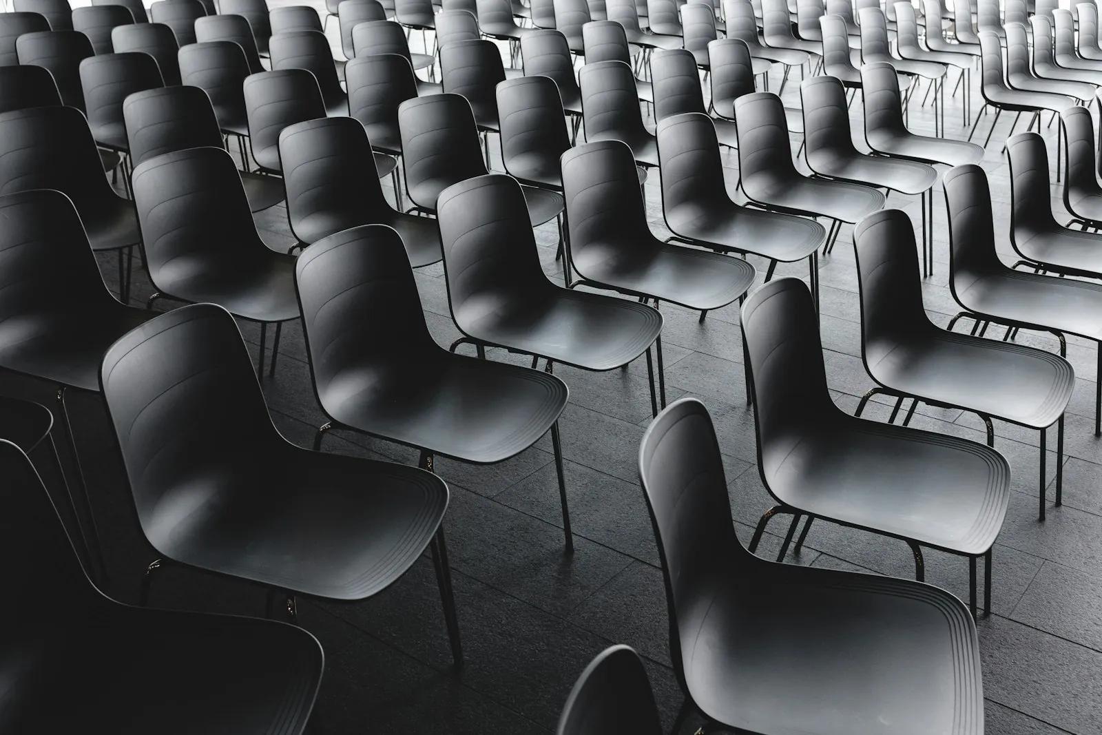 Rows of empty black chairs