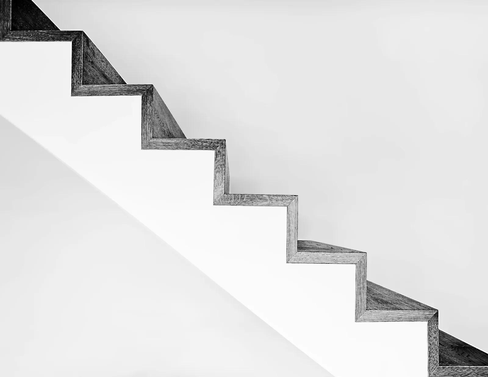 Minimal white stairs rising diagonally