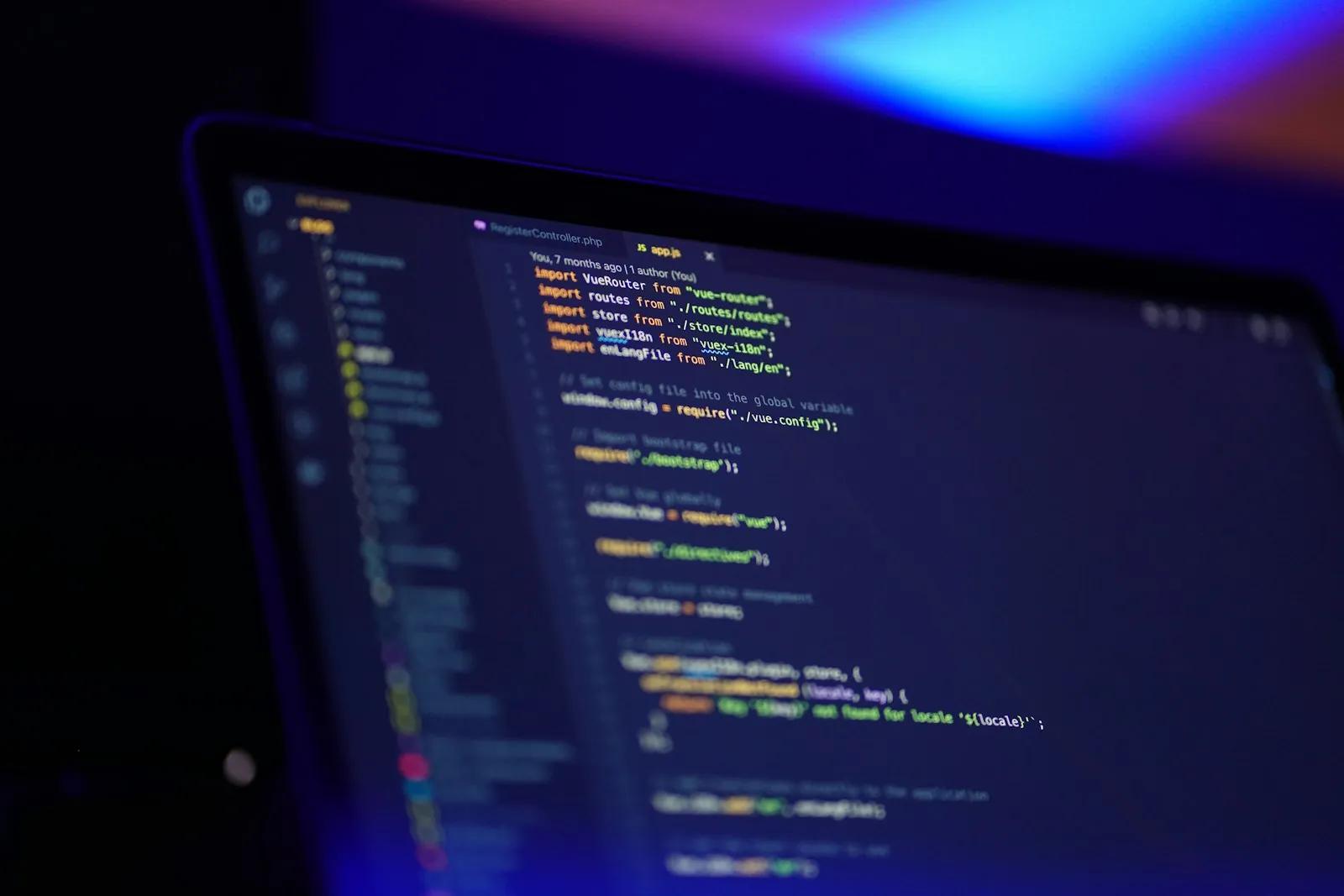 A laptop screen displaying colorful code