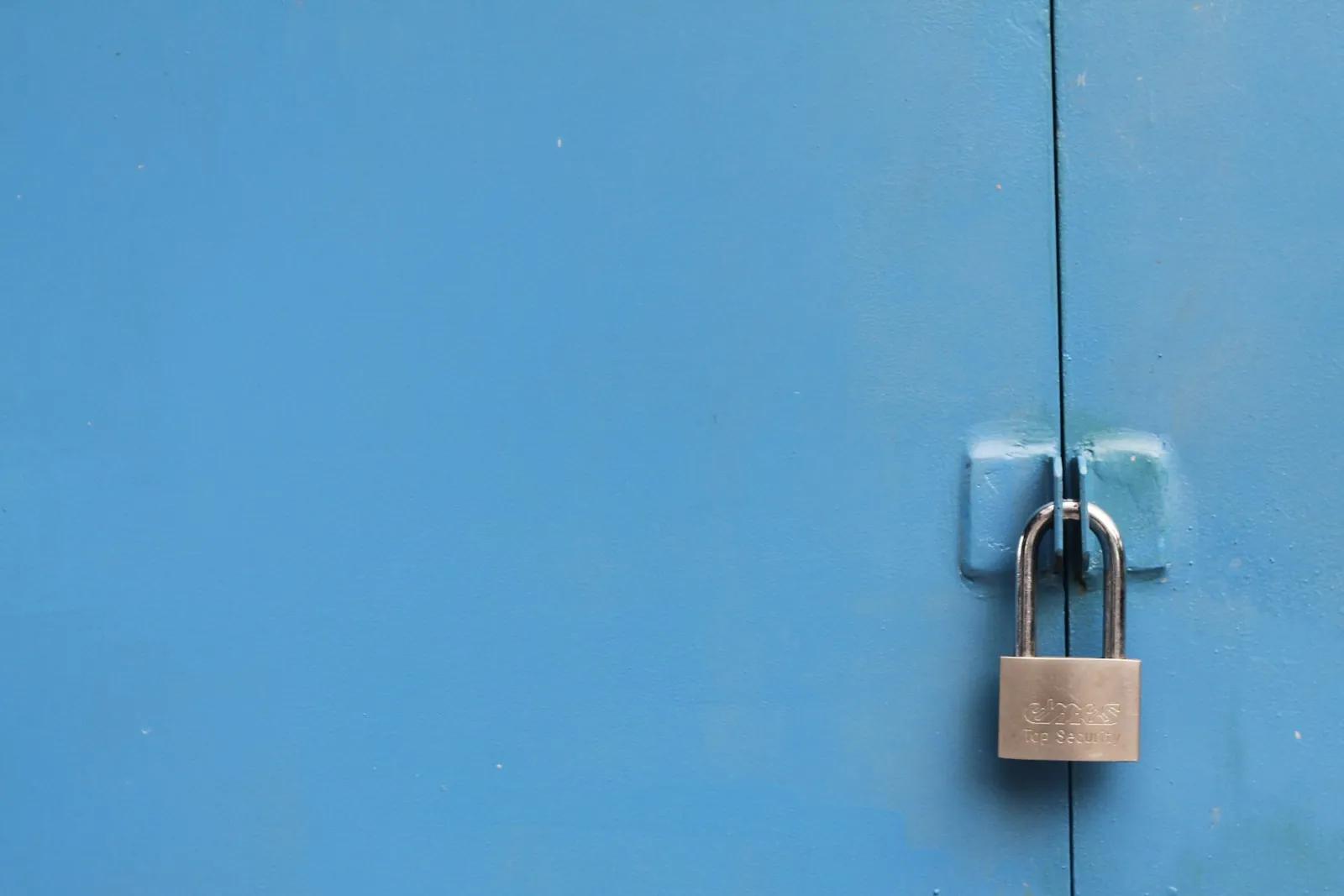 A silver padlock against a plain background