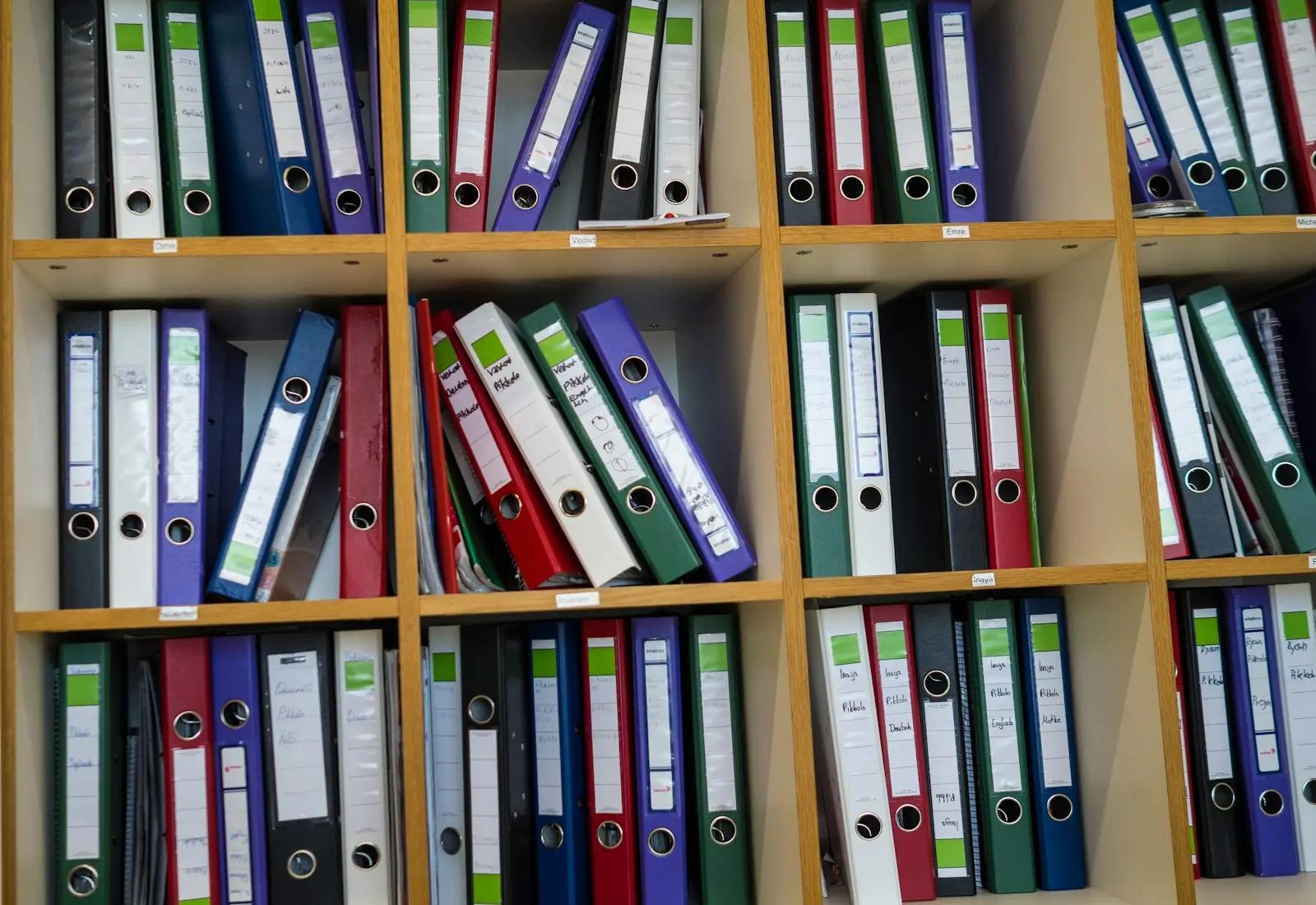 Wooden shelves filled with colorful ring binders