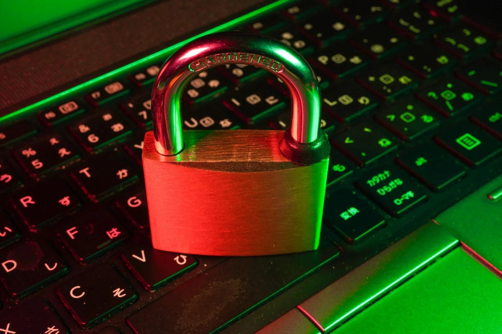Red padlock resting on a black keyboard