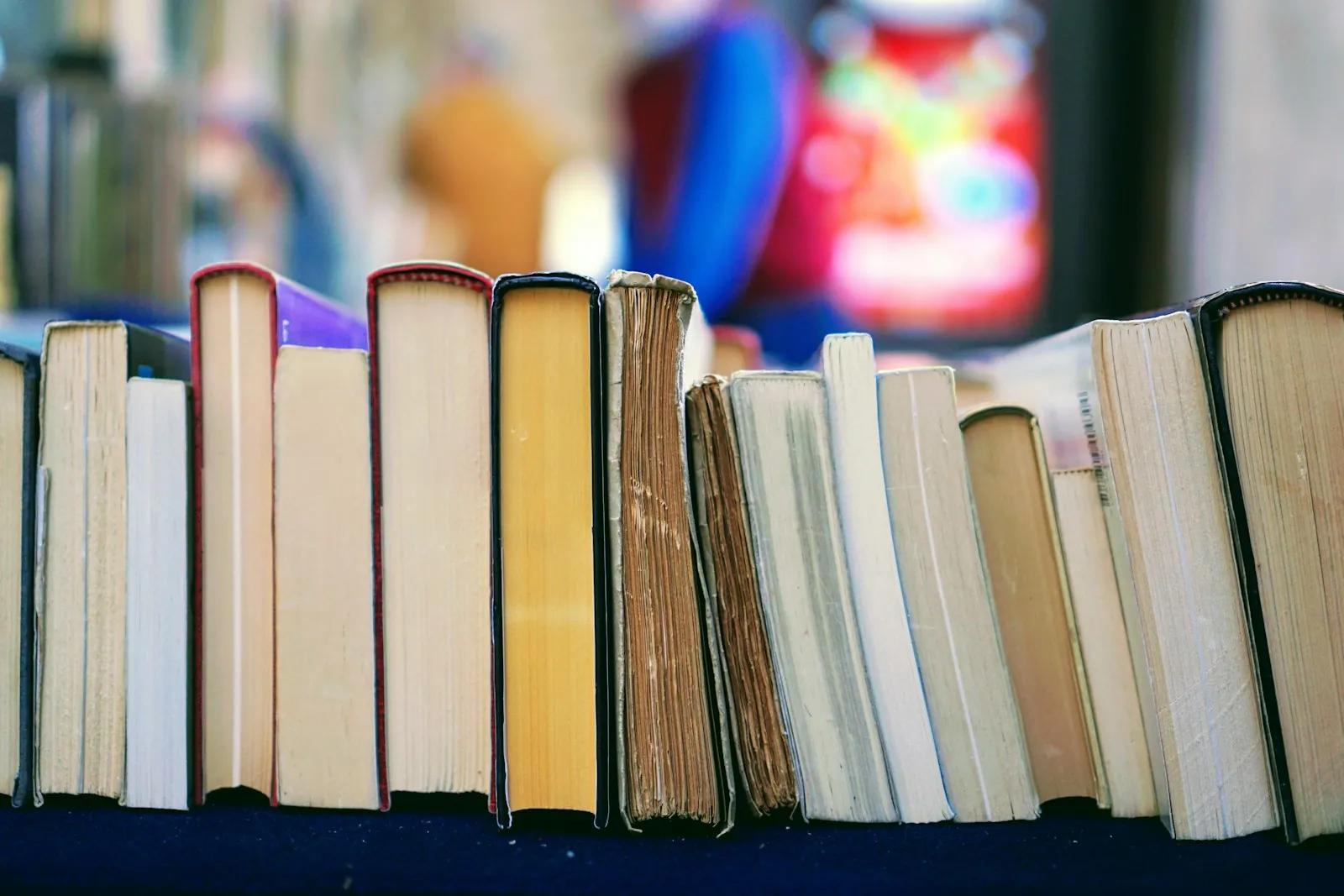 A row of old books standing on a table