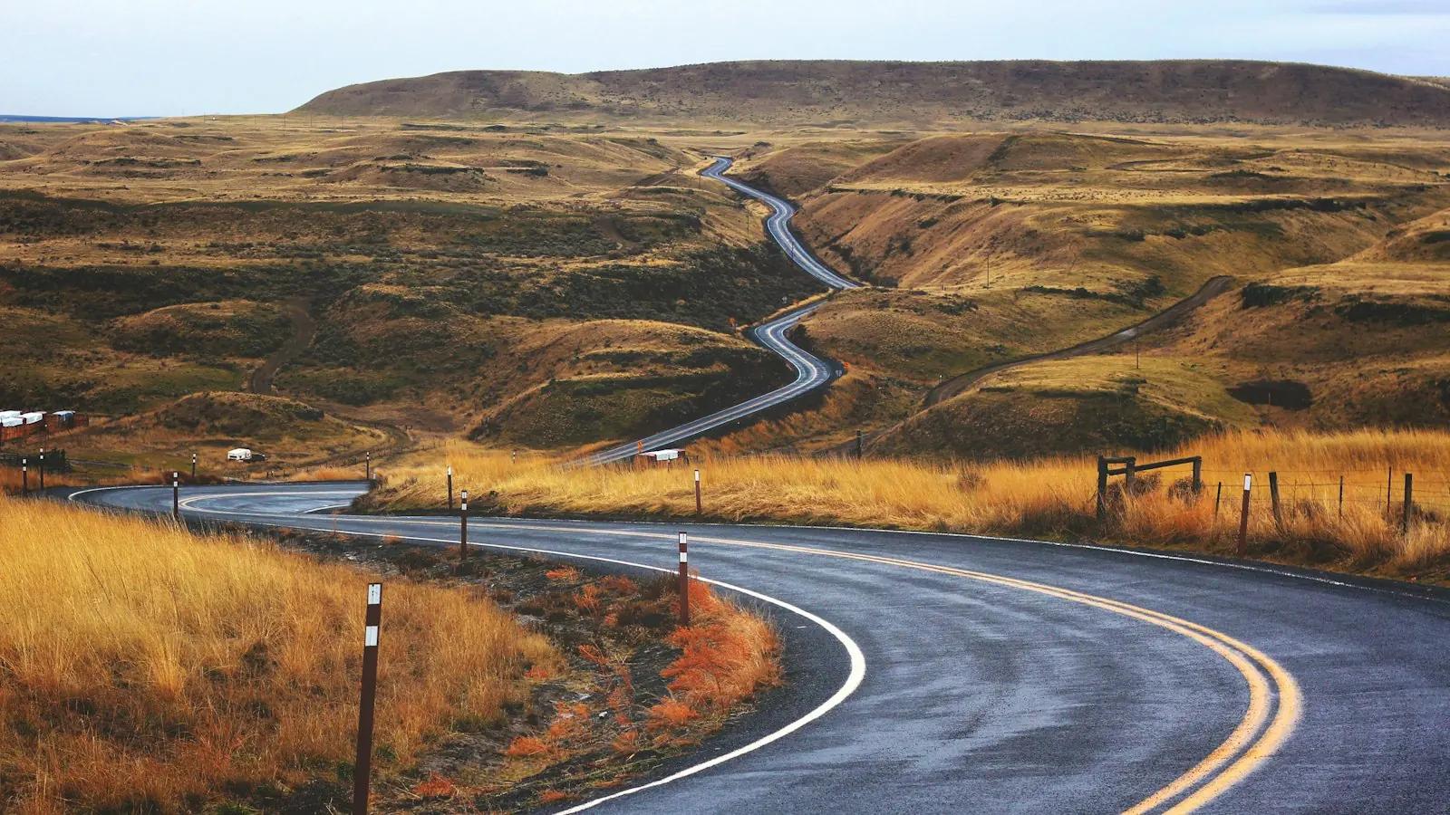 A road winding through a brown valley