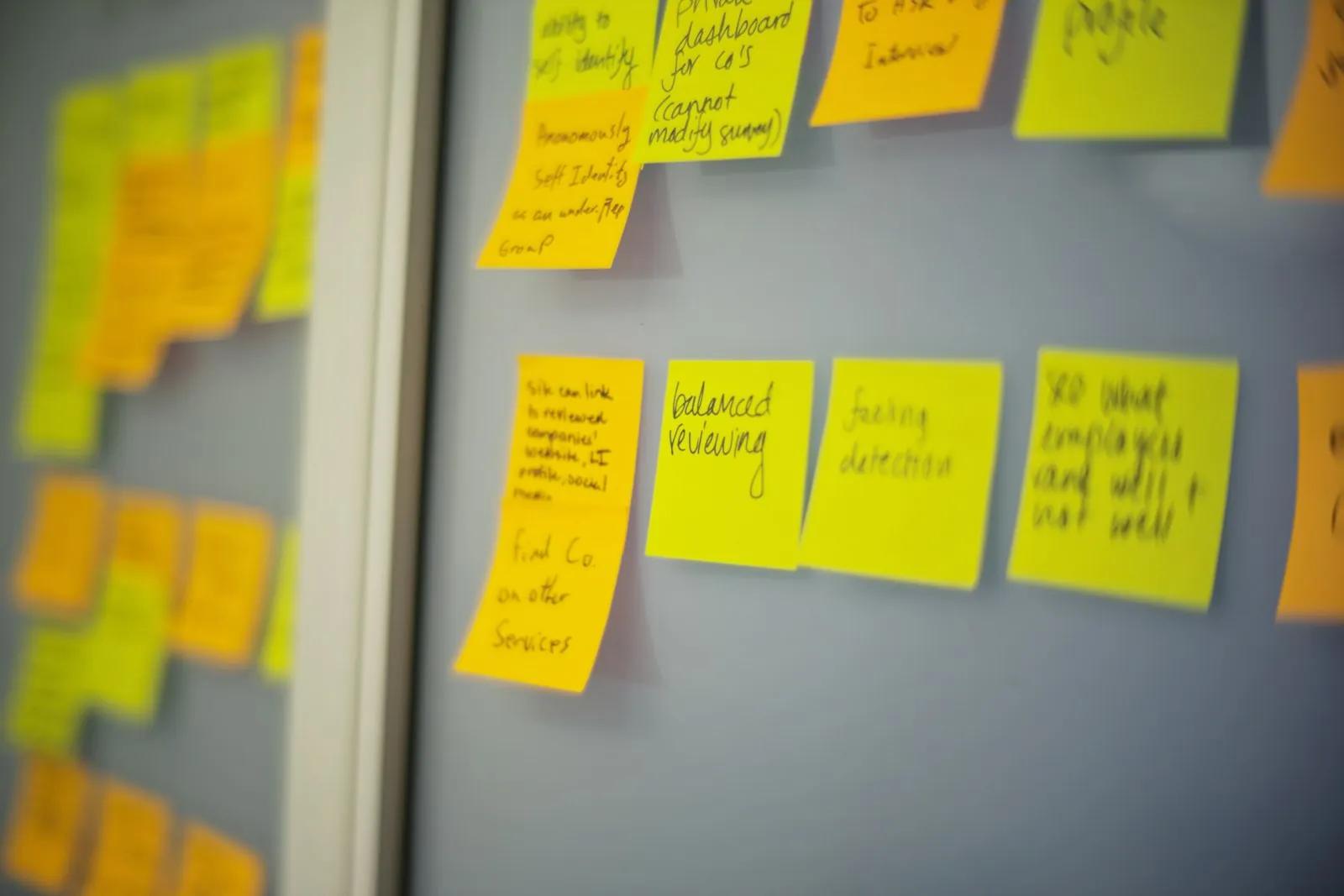 Yellow and orange sticky notes on a wall